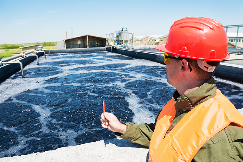 Man inspecting industrial wastewater